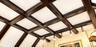 Coffered ceiling featuring dark wood-finish beams and integrated directional track lighting