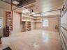 Large and deep 3-car garage with extra tall doors for large trucks/vehicles.