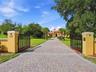 Private gated entrance to the estate with long brick paver driveway! No detail left untouched!