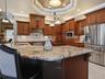 Upgraded wood cabinetry and granite countertops elevate the space!