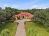 Gorgeous tile roof and long private paver driveway with gated entrance!