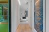 Hallway featuring wood-finish flooring, recessed lighting, and expansive floor-to-ceiling glass wall panels