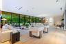 Open-concept interior featuring floor-to-ceiling glass walls, light-toned wood-finish flooring, recessed ceiling lighting, and custom linear architect