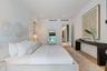 Spacious room featuring light-toned wood-finish flooring, recessed ceiling lighting, and smooth white walls