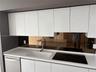 Kitchen featuring high-gloss white cabinetry, white stone-composite countertop, integrated white sink with chrome arched faucet, and a mirrored backsp