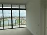 Floor-to-ceiling windows with clerestory panels, sliding glass door access to a private balcony, metal railing, and neutral large-format tile flooring