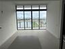 Floor-to-ceiling glass sliding doors, large-format tile flooring, transom windows, and a private balcony with metal railing
