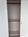 Sliding closet doors featuring a white finish, horizontal shelving, built-in rods, and a square metal handle