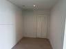 Neutral-toned oversized tile flooring and a double-door closet featuring white louvered panels and recessed lighting- Could be use as a 3rd Bed, Famil