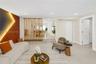 Living area featuring a vertical-slat wood room divider, textured accent wall with recessed lighting, smooth-finish flooring, and recessed ceiling lig