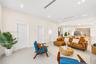 Neutral interior featuring recessed lighting, smooth ceiling finish, three-panel interior doors, light-toned tile flooring, and a decorative vertical 