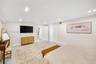 Neutral-toned walls, recessed lighting, and closet doors with recessed panels