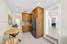 Kitchenette featuring wood-finish cabinetry, stainless steel refrigerator, stone-surface countertop, and recessed lighting