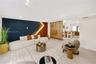 Living area featuring a floor-to-ceiling wooden slat partition, recessed lighting, and a dual-tone accent wall with integrated LED strip lighting