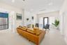 Living area featuring large-format tile flooring, recessed ceiling lighting, a textured floor-to-ceiling fireplace surround, and a glass-paneled exter
