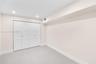 Neutral-toned interior space featuring recessed ceiling lighting and a four-panel bi-fold closet