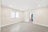 Neutral-toned tile flooring, recessed ceiling lighting, and a three-panel interior door