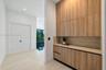 Built-in cabinetry featuring wood-finish cabinetry, light-toned countertop, recessed ceiling lighting, and smooth surface flooring