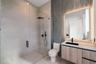 Walk-in shower with a glass enclosure and rain-style showerhead, floating vanity with wood-finish cabinetry, countertop vessel sink, matte black hardw
