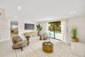 Neutral-toned interior featuring recessed lighting, polished light-colored flooring, and large sliding glass doors