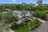Elevated aerial perspective of the home with the city skyline in the distance