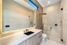 Modern bath with floating vanity, large format tile, and frameless glass shower