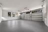 Oversized garage with epoxy floors and ample room for vehicles and storage