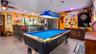 Main Home - Great room/kitchen/living room combo: Living room used as gathering space for game room fun. Two Sliders go out to covered back porch and 