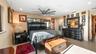 Primary with private bath and amazing lakefront views. Private exit to screened in back porch to back yard