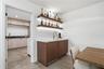 Wet Bar with Ice Machine and Laundry Beyond