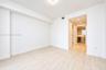 Neutral-toned tile flooring, smooth wall finishes, and recessed lighting