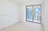 Interior space featuring wood-finish flooring, floor-to-ceiling sliding glass doors, and a private balcony