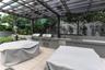 Outdoor kitchen featuring dual stainless steel grills, integrated stainless steel storage, a built-in sink, and a permanent pergola structure set over