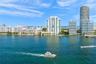 Waterfront perspective featuring high-rise towers, marine channel, and coastal horizon
