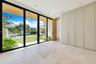 Floor-to-ceiling multi-panel glass doors, stone tile flooring, floor-to-ceiling integrated cabinetry, recessed lighting, and wood-finish ceiling detai