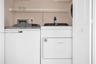 Laundry closet featuring a wire storage shelf and bi-fold door