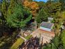 Aerial view of detached garage and driveway with natural stone pavers
