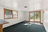 Freshly painted living room with sliding glass doors and wood-framed windows