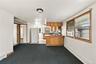 Kitchen featuring solid wood cabinetry, a breakfast bar, and neutral tile flooring