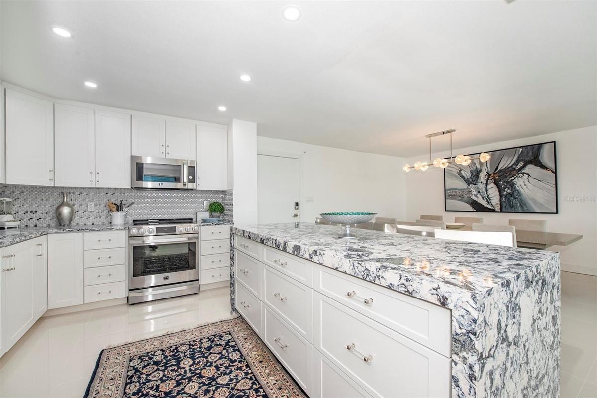 Kitchen has an open layout and center island with buffet seating for four...