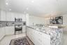 Kitchen has an open layout and center island with buffet seating for four...