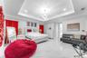 Tray ceiling with recessed lighting, large-format tile flooring, and multi-arm chandelier