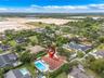 Aerial perspective featuring a tile roof, an in-ground swimming pool, and mature perimeter landscaping
