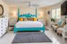 Bedroom featuring tile flooring, plantation shutters, and a ceiling fan with palm-leaf style blades