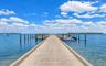 Concrete deep-water dock featuring multiple pilings for watercraft mooring and open-water access