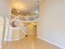 Two-story foyer featuring high ceilings, tile flooring, an open staircase with white balusters, arched entryways, and pendant lighting