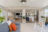 Covered patio featuring a stacked stone accent wall, recessed lighting, a ceiling fan, and large-format tile flooring