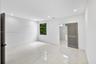 Neutral-toned polished tile flooring, recessed ceiling lighting, louvered panel door, and built-in shelving unit