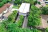 Two-story modern exterior featuring a flat roof, paver driveway, linear concrete pavers, and surrounding mature landscaping