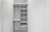 Built-in closet system featuring white shelving, adjustable rack pinholes, and a metal hanging rod